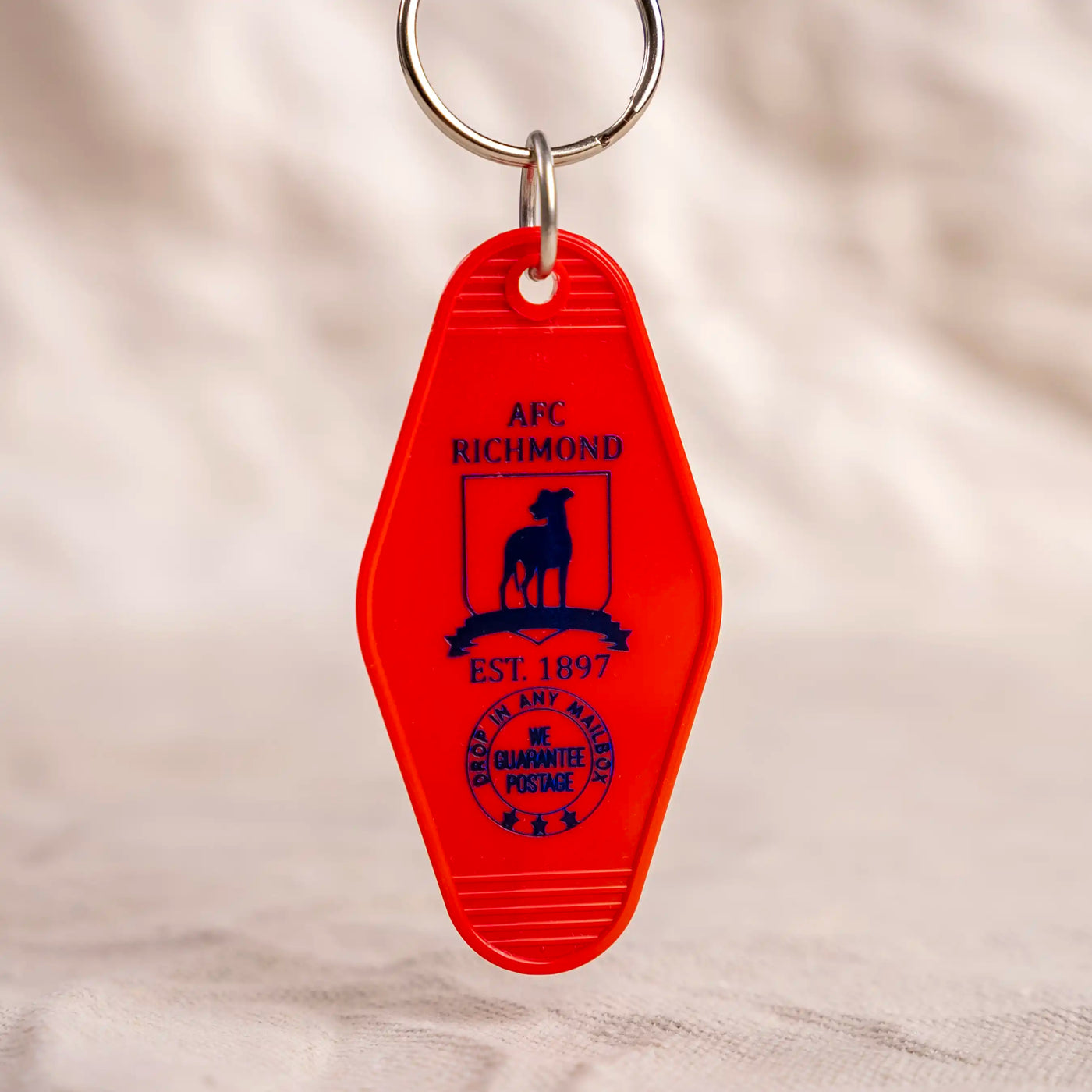 AFC Ricmond Motel Key Fob. Red key fob with navy logo.