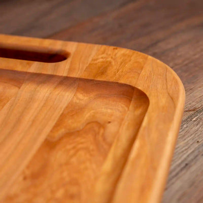 Cherry Barbecue Board with handles. Close up of raised edge.