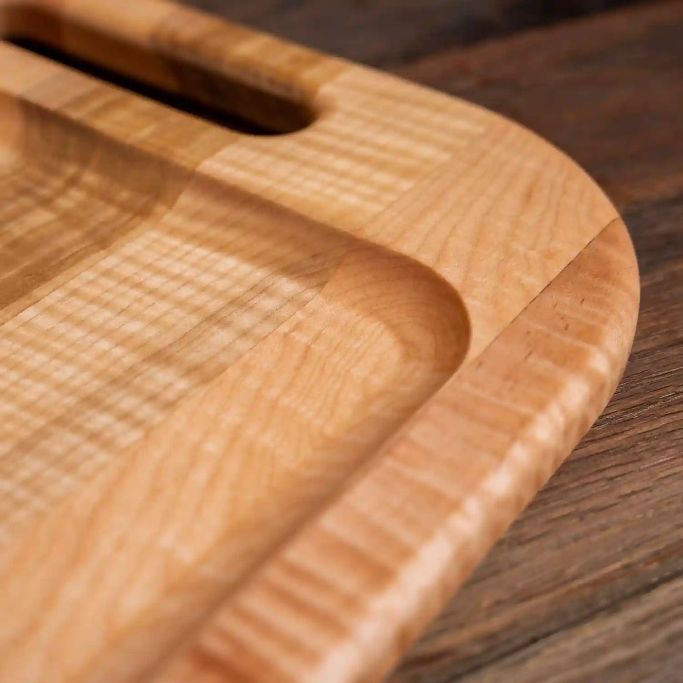 Curly Maple Barbecue Board. Close up of raised edge.