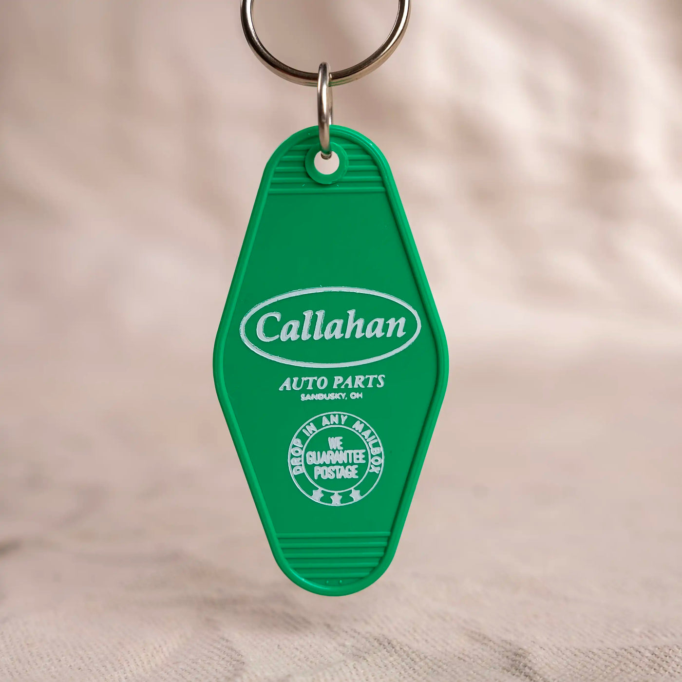 Callahan Auto Parts motel ket fob. Green key fob with white logo and lettering. 