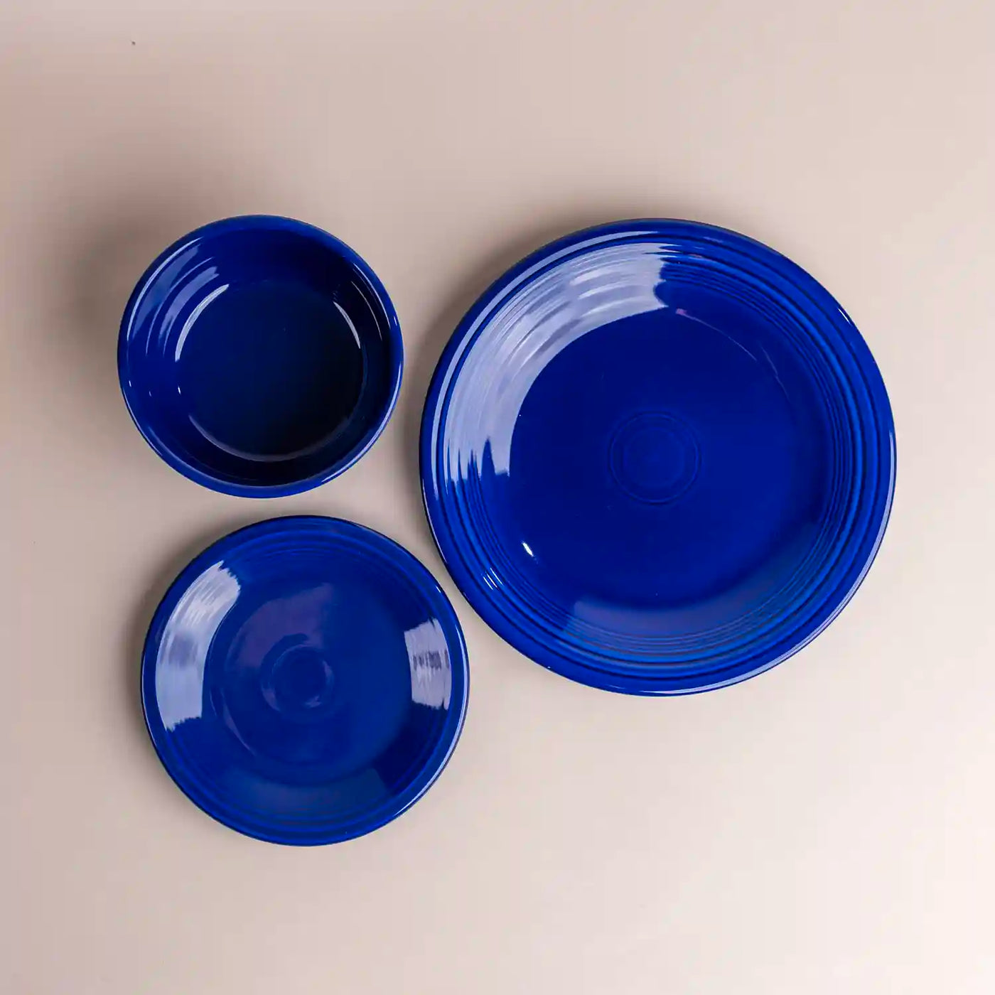 Fiesta twilight blue dinner plate salad plate and gusto bowl. Lay flat. Aerial view. 