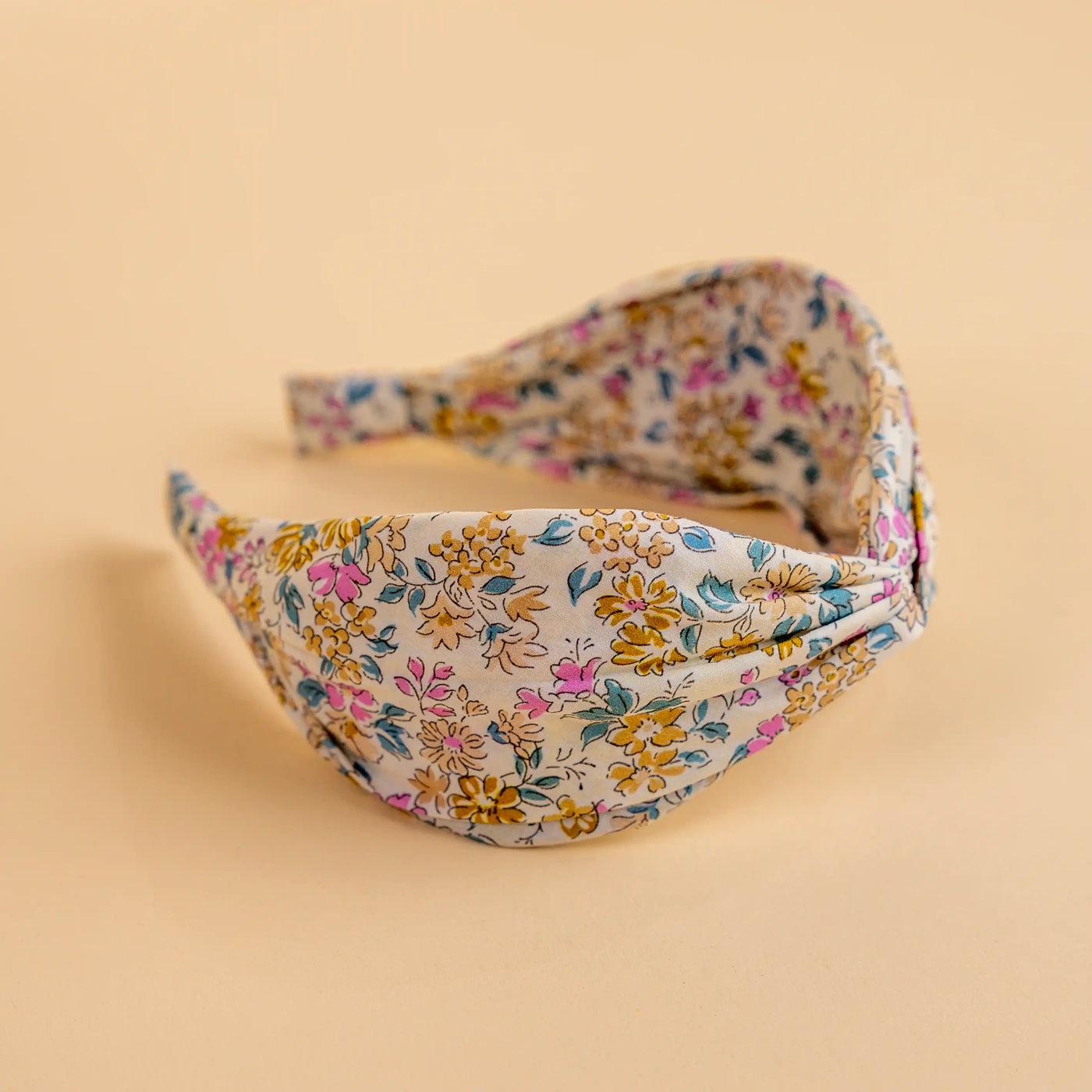 Lucy's Ivory Poppy Floral Headband. Ivory background with pink and yellow flowers. Side view. 