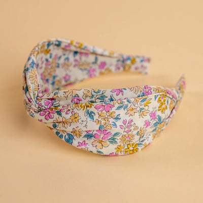 Lucy's Ivory Poppy Floral Headband. Ivory background with pink and yellow flowers. Side view.