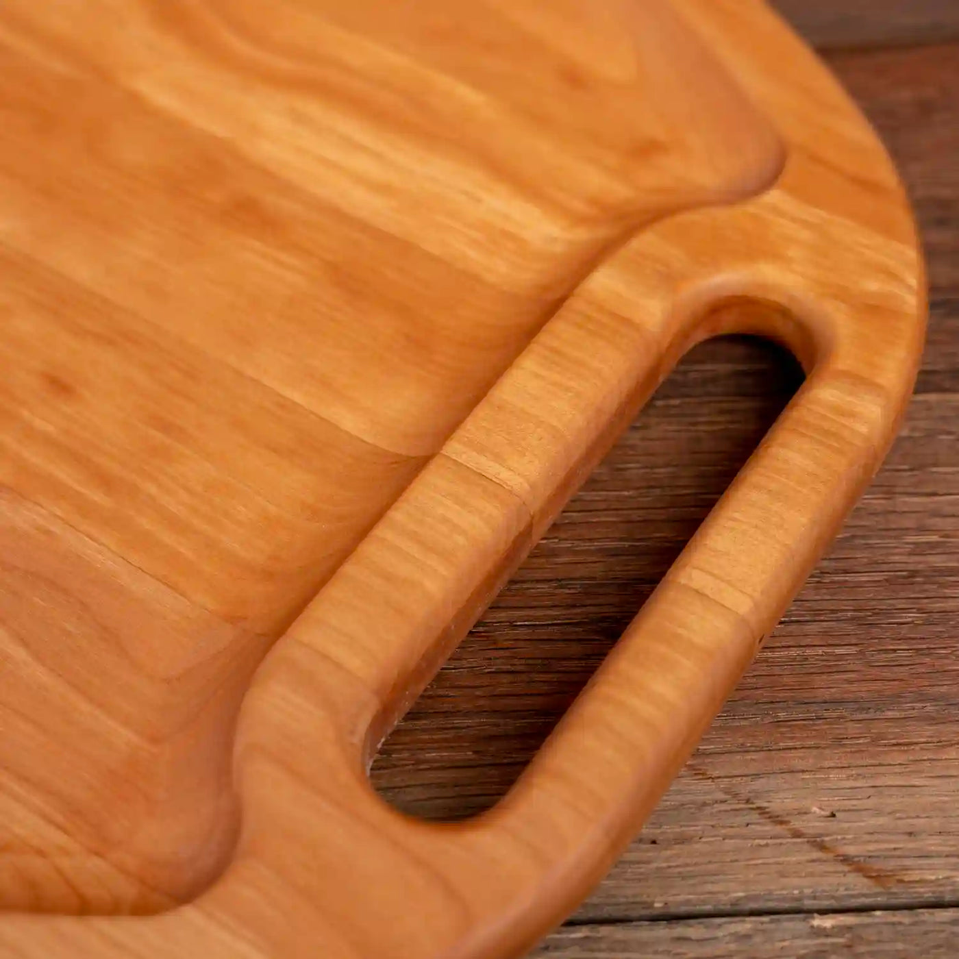 Cherry Oval Barbecue Board. Close up of handle.