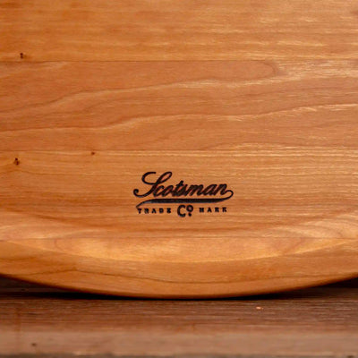 Cherry Oval Barbecue Board. Close up of Scotsman logo.