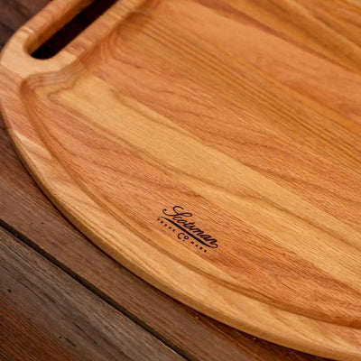Red Oak Oval Barbecue Board. Close up of Scotsman logo.